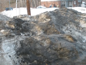 Discolored snow piles